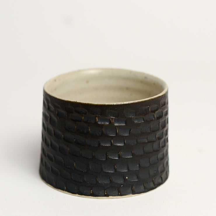 Ceramic whiskey cup handmade by Melbourne based maker eb Ceramics. This piece is part of an exclusive range created especially for pépite - all pieces were hand thrown by eb and later hand carved in a unique pattern inspired by French cobblestone roads and finished with one of three signature glaze recipes.