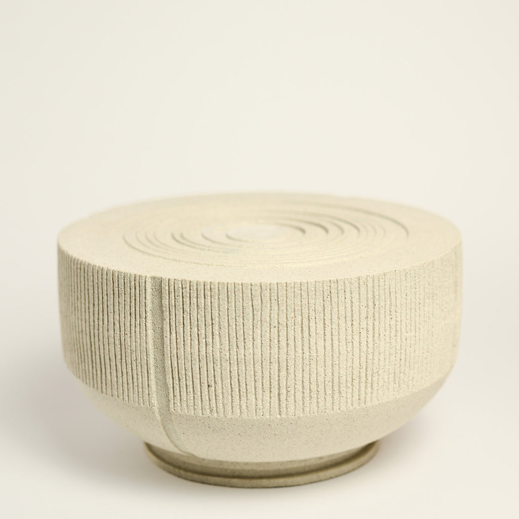 From her small studio in the Dandenong Ranges, Melinda Wallis strives for beauty in the form and surface. Simple designs can prove challenging, however this keeps her engaged as she continues to search for that one perfect piece. that enigma. She uses textured clays, often blending two or three together. The wheel gives Melinda her individual parts, and her hands assemble the finished product. The process is by far the main event for Melinda.