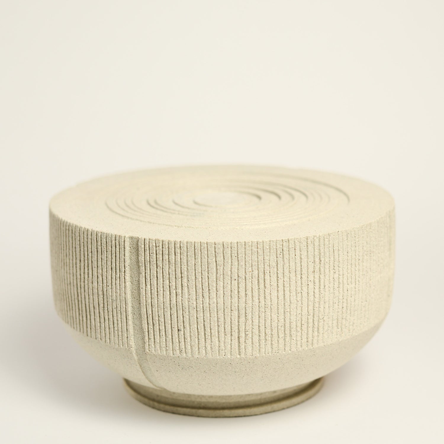 From her small studio in the Dandenong Ranges, Melinda Wallis strives for beauty in the form and surface. Simple designs can prove challenging, however this keeps her engaged as she continues to search for that one perfect piece. that enigma. She uses textured clays, often blending two or three together. The wheel gives Melinda her individual parts, and her hands assemble the finished product. The process is by far the main event for Melinda.