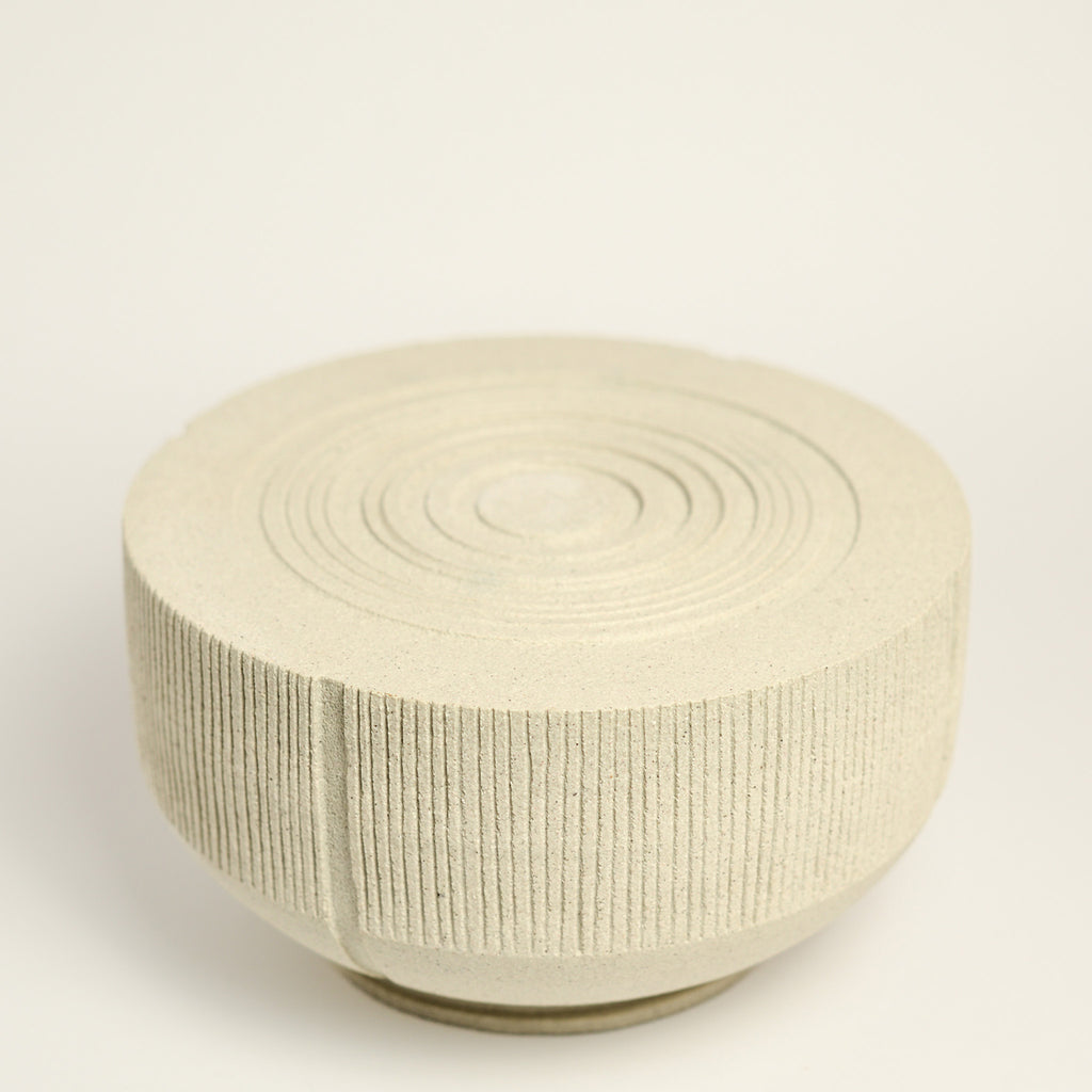 From her small studio in the Dandenong Ranges, Melinda Wallis strives for beauty in the form and surface. Simple designs can prove challenging, however this keeps her engaged as she continues to search for that one perfect piece. that enigma. She uses textured clays, often blending two or three together. The wheel gives Melinda her individual parts, and her hands assemble the finished product. The process is by far the main event for Melinda.