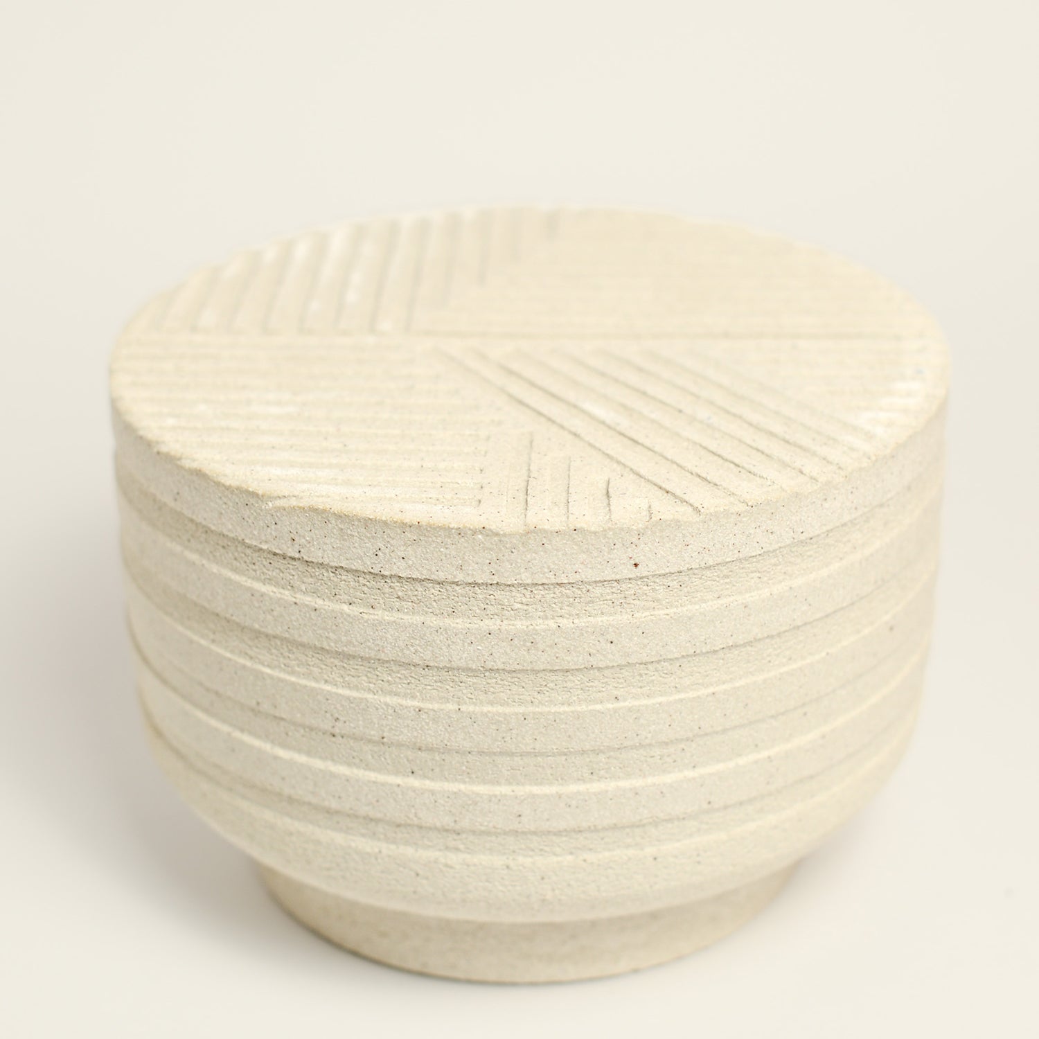 From her small studio in the Dandenong Ranges, Melinda Wallis strives for beauty in the form and surface. Simple designs can prove challenging, however this keeps her engaged as she continues to search for that one perfect piece. that enigma. She uses textured clays, often blending two or three together. The wheel gives Melinda her individual parts, and her hands assemble the finished product. The process is by far the main event for Melinda.