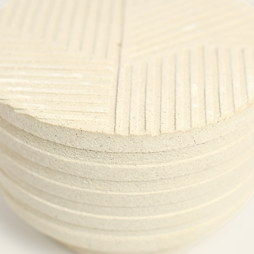 From her small studio in the Dandenong Ranges, Melinda Wallis strives for beauty in the form and surface. Simple designs can prove challenging, however this keeps her engaged as she continues to search for that one perfect piece. that enigma. She uses textured clays, often blending two or three together. The wheel gives Melinda her individual parts, and her hands assemble the finished product. The process is by far the main event for Melinda.