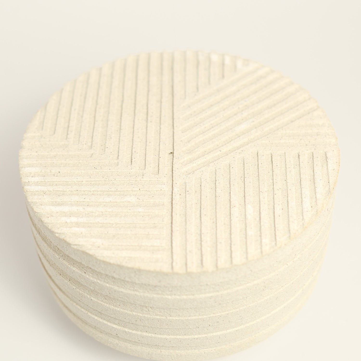 From her small studio in the Dandenong Ranges, Melinda Wallis strives for beauty in the form and surface. Simple designs can prove challenging, however this keeps her engaged as she continues to search for that one perfect piece. that enigma. She uses textured clays, often blending two or three together. The wheel gives Melinda her individual parts, and her hands assemble the finished product. The process is by far the main event for Melinda.