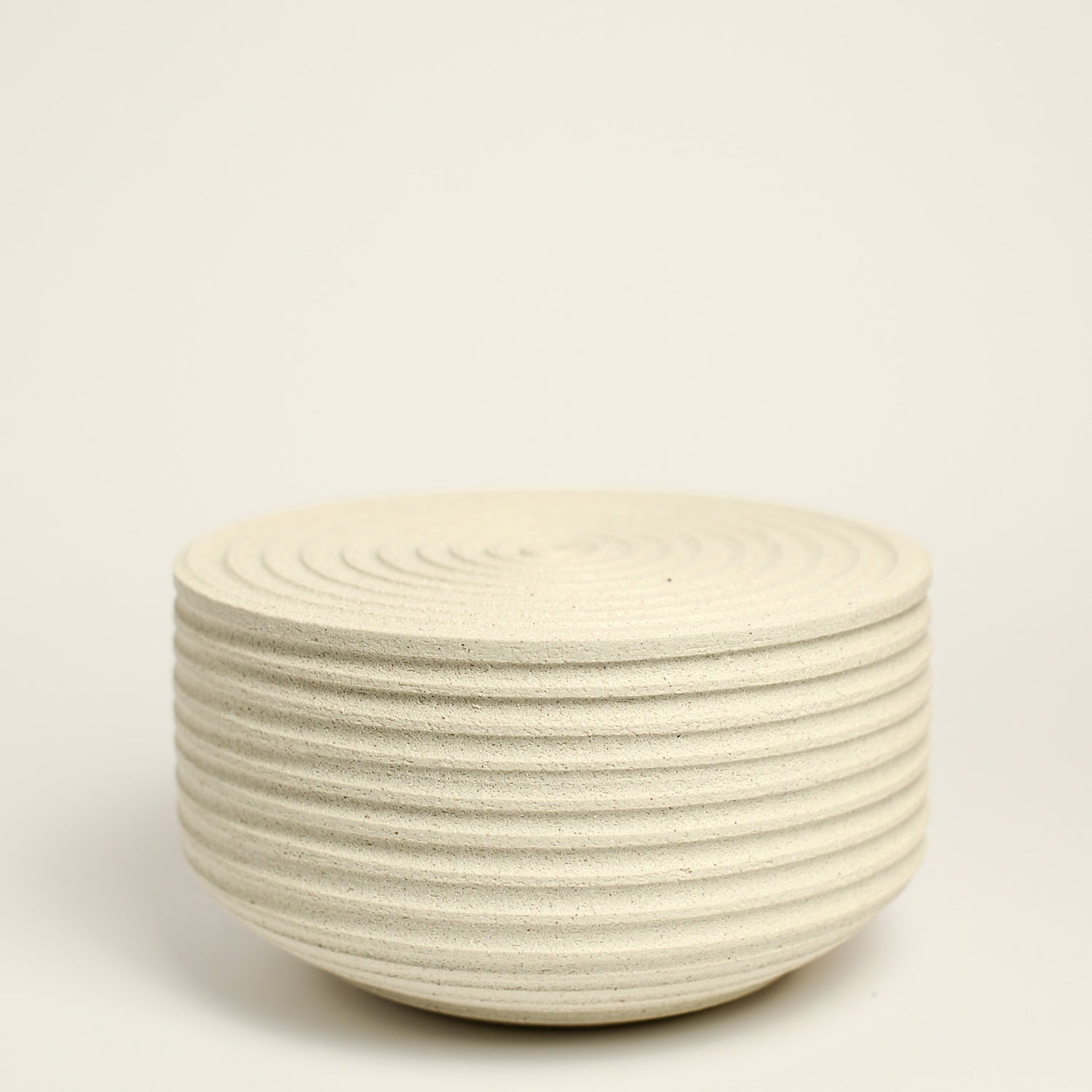 From her small studio in the Dandenong Ranges, Melinda Wallis strives for beauty in the form and surface. Simple designs can prove challenging, however this keeps her engaged as she continues to search for that one perfect piece. that enigma. She uses textured clays, often blending two or three together. The wheel gives Melinda her individual parts, and her hands assemble the finished product. The process is by far the main event for Melinda.