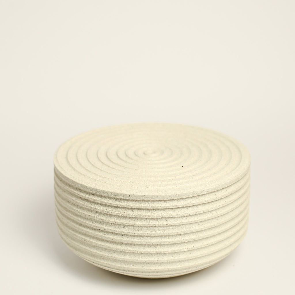 From her small studio in the Dandenong Ranges, Melinda Wallis strives for beauty in the form and surface. Simple designs can prove challenging, however this keeps her engaged as she continues to search for that one perfect piece. that enigma. She uses textured clays, often blending two or three together. The wheel gives Melinda her individual parts, and her hands assemble the finished product. The process is by far the main event for Melinda.