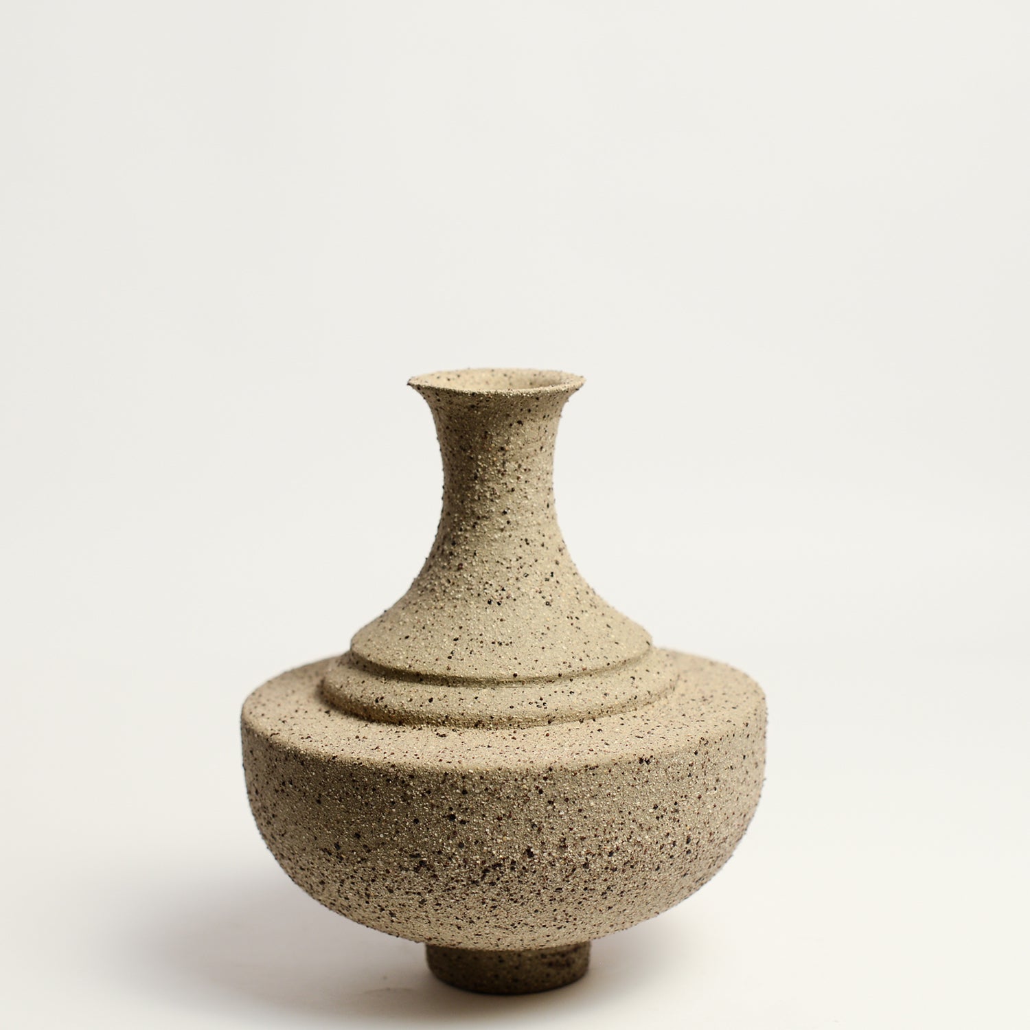 From her small studio in the Dandenong Ranges, Melinda Wallis strives for beauty in the form and surface. Simple designs can prove challenging, however this keeps her engaged as she continues to search for that one perfect piece. that enigma. She uses textured clays, often blending two or three together. The wheel gives Melinda her individual parts, and her hands assemble the finished product. The process is by far the main event for Melinda.