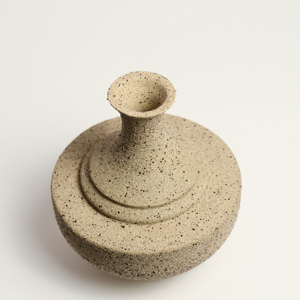 From her small studio in the Dandenong Ranges, Melinda Wallis strives for beauty in the form and surface. Simple designs can prove challenging, however this keeps her engaged as she continues to search for that one perfect piece. that enigma. She uses textured clays, often blending two or three together. The wheel gives Melinda her individual parts, and her hands assemble the finished product. The process is by far the main event for Melinda.