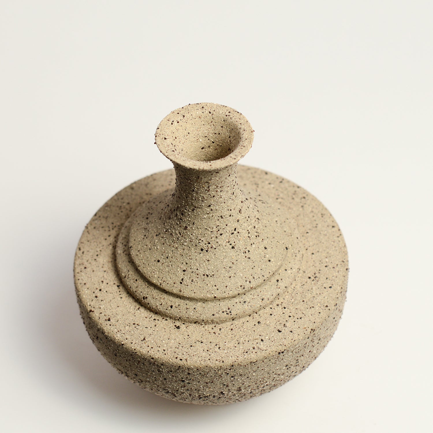 From her small studio in the Dandenong Ranges, Melinda Wallis strives for beauty in the form and surface. Simple designs can prove challenging, however this keeps her engaged as she continues to search for that one perfect piece. that enigma. She uses textured clays, often blending two or three together. The wheel gives Melinda her individual parts, and her hands assemble the finished product. The process is by far the main event for Melinda.