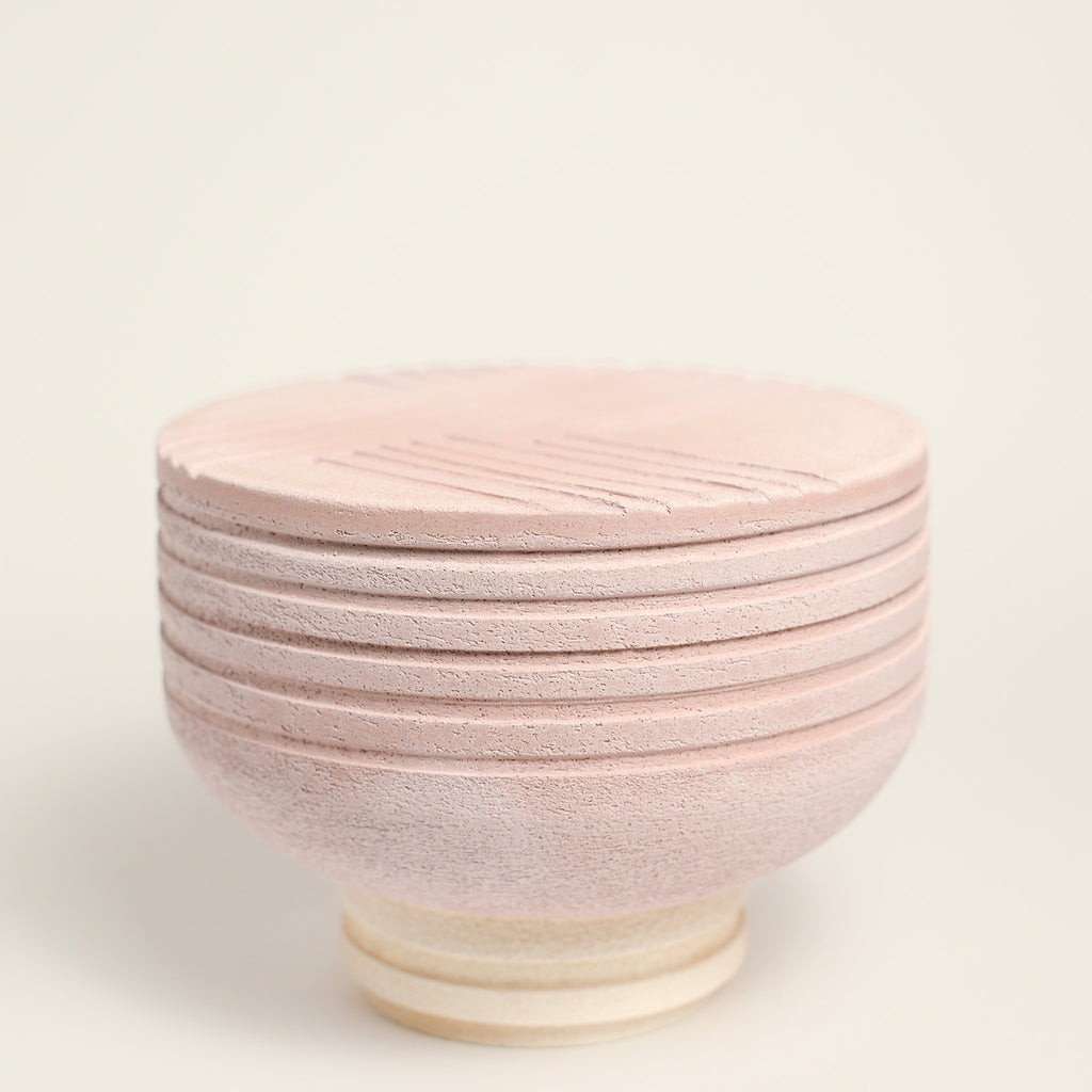 From her small studio in the Dandenong Ranges, Melinda Wallis strives for beauty in the form and surface. Simple designs can prove challenging, however this keeps her engaged as she continues to search for that one perfect piece. that enigma. She uses textured clays, often blending two or three together. The wheel gives Melinda her individual parts, and her hands assemble the finished product. The process is by far the main event for Melinda.