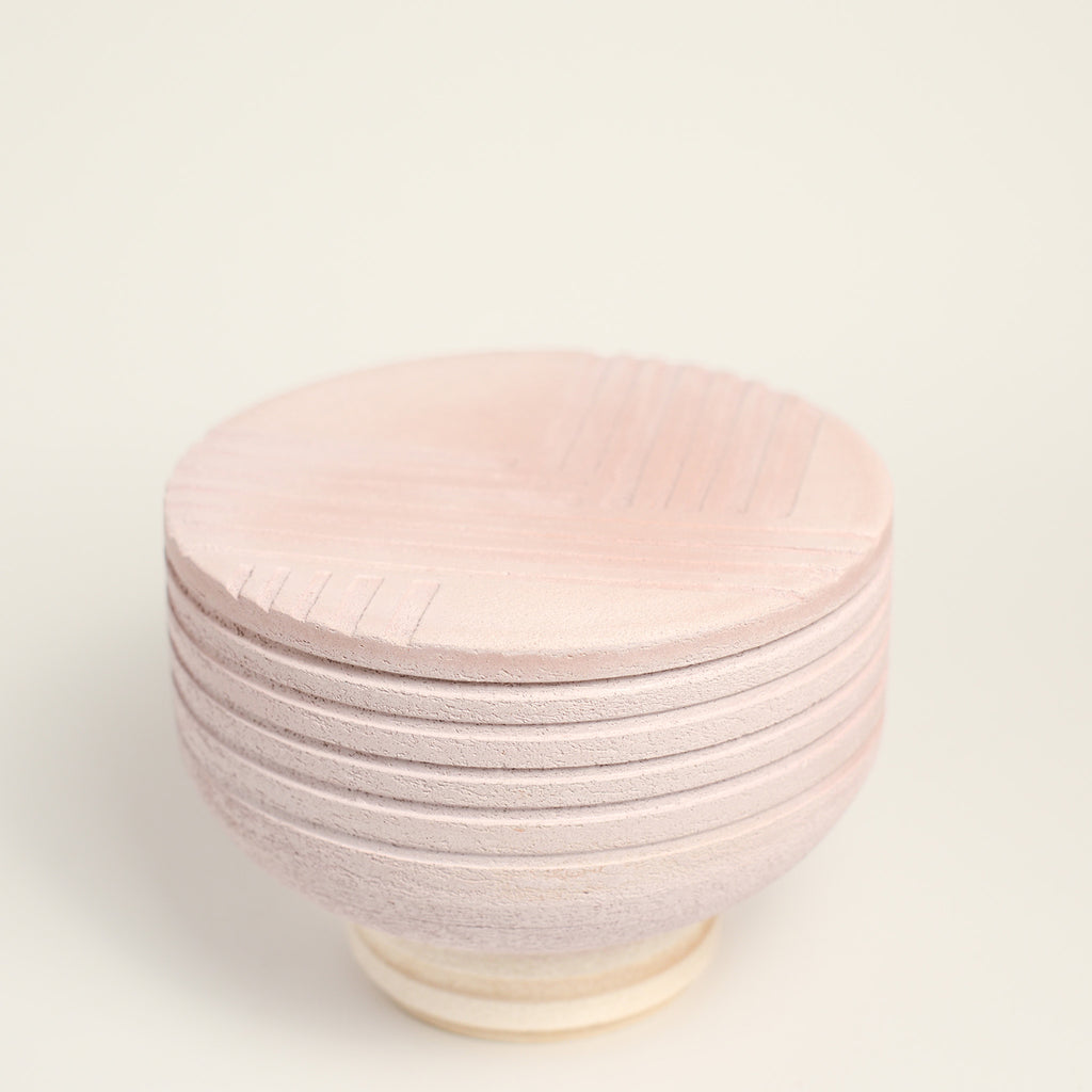 From her small studio in the Dandenong Ranges, Melinda Wallis strives for beauty in the form and surface. Simple designs can prove challenging, however this keeps her engaged as she continues to search for that one perfect piece. that enigma. She uses textured clays, often blending two or three together. The wheel gives Melinda her individual parts, and her hands assemble the finished product. The process is by far the main event for Melinda.