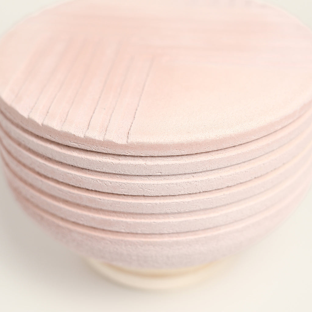 From her small studio in the Dandenong Ranges, Melinda Wallis strives for beauty in the form and surface. Simple designs can prove challenging, however this keeps her engaged as she continues to search for that one perfect piece. that enigma. She uses textured clays, often blending two or three together. The wheel gives Melinda her individual parts, and her hands assemble the finished product. The process is by far the main event for Melinda.