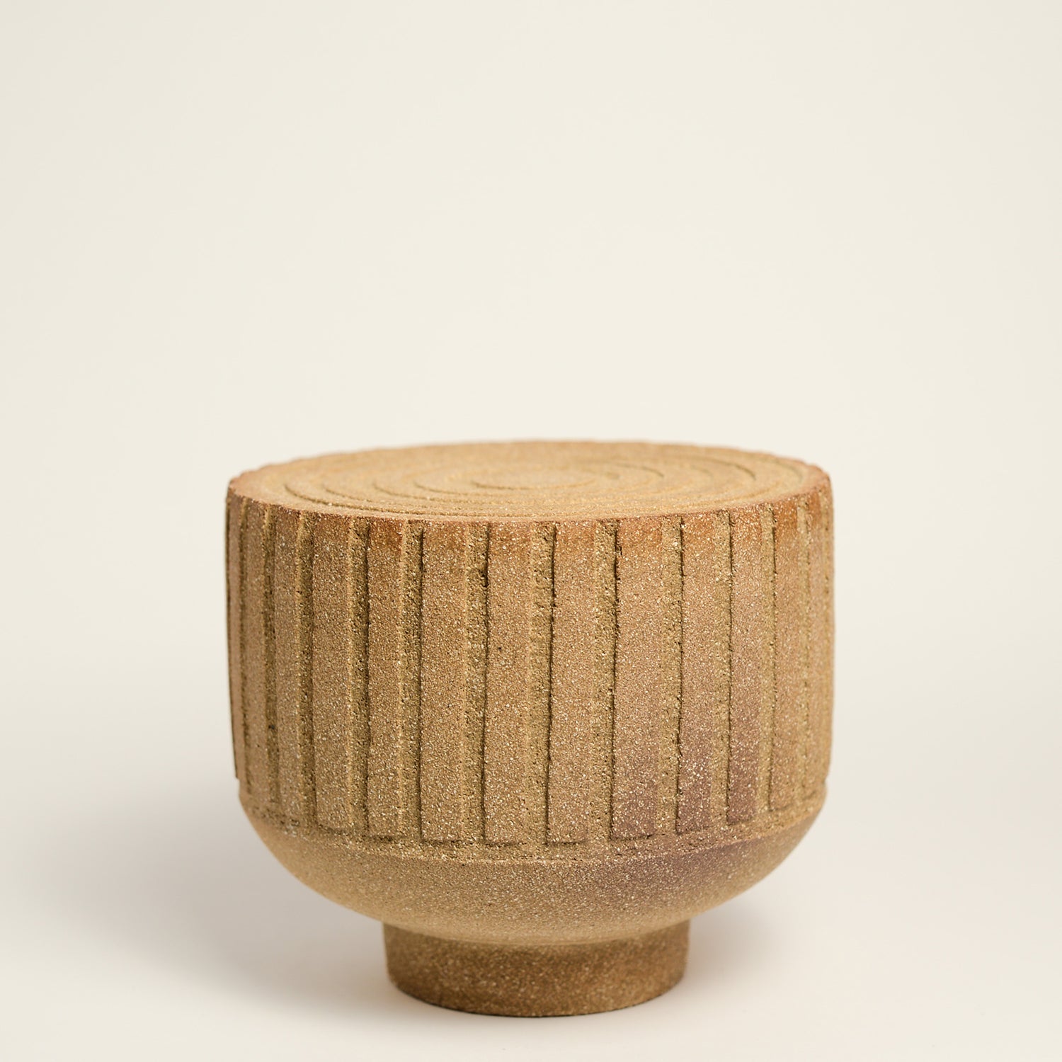 From her small studio in the Dandenong Ranges, Melinda Wallis strives for beauty in the form and surface. Simple designs can prove challenging, however this keeps her engaged as she continues to search for that one perfect piece. that enigma. She uses textured clays, often blending two or three together. The wheel gives Melinda her individual parts, and her hands assemble the finished product. The process is by far the main event for Melinda.