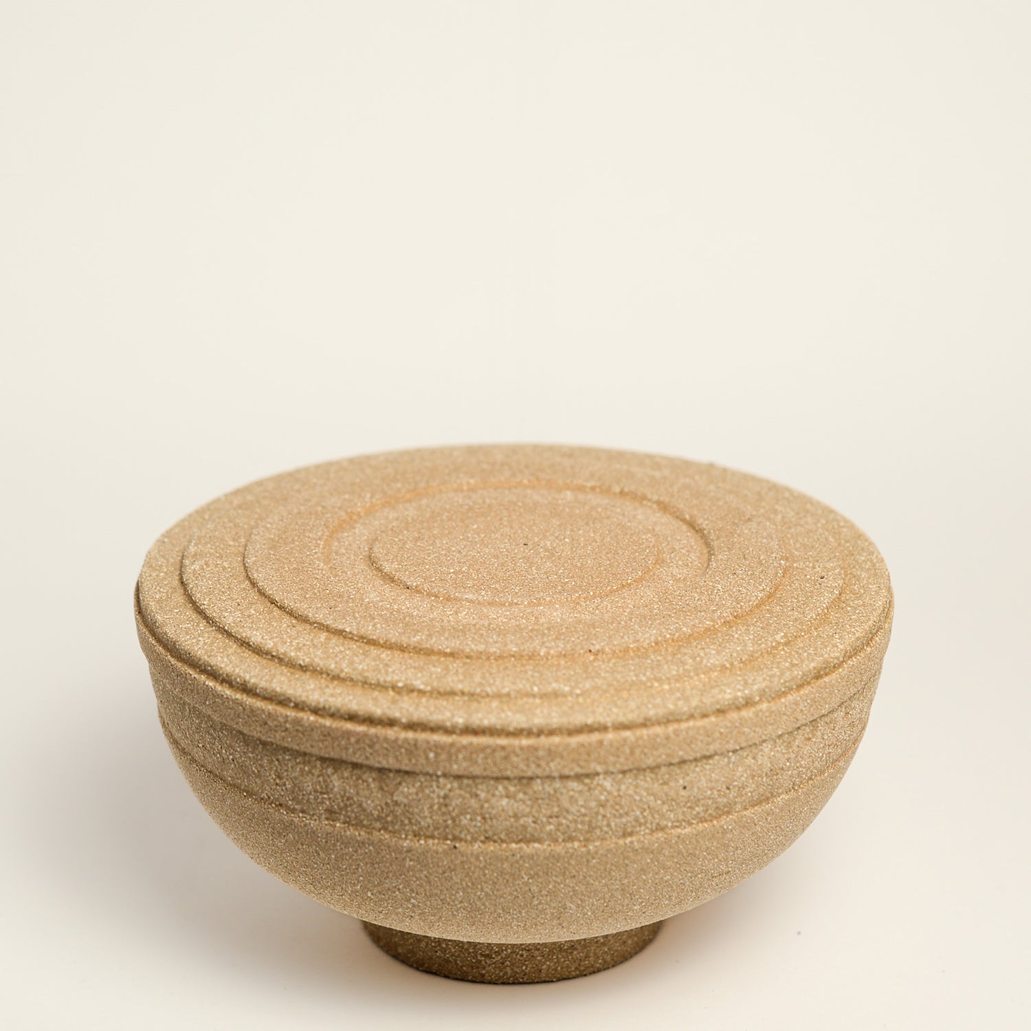 From her small studio in the Dandenong Ranges, Melinda Wallis strives for beauty in the form and surface. Simple designs can prove challenging, however this keeps her engaged as she continues to search for that one perfect piece. that enigma. She uses textured clays, often blending two or three together. The wheel gives Melinda her individual parts, and her hands assemble the finished product. The process is by far the main event for Melinda.