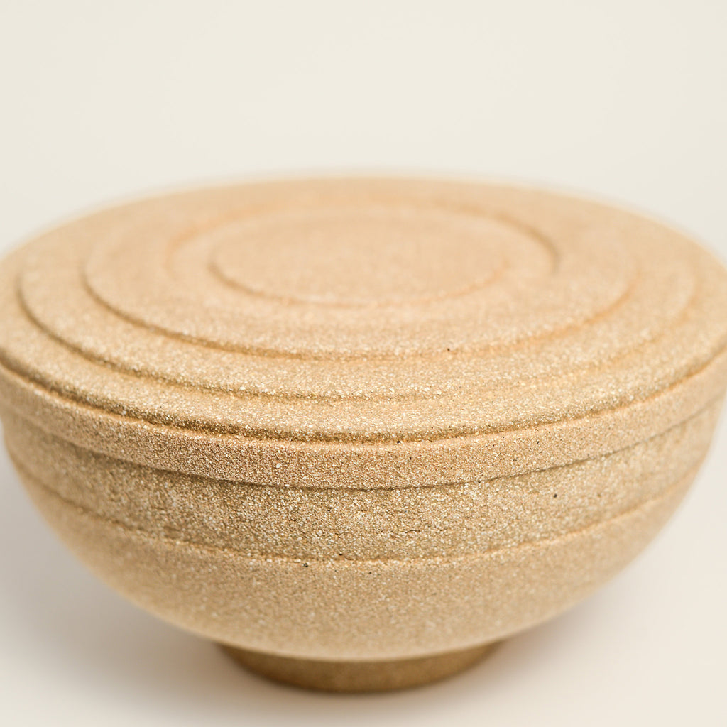 From her small studio in the Dandenong Ranges, Melinda Wallis strives for beauty in the form and surface. Simple designs can prove challenging, however this keeps her engaged as she continues to search for that one perfect piece. that enigma. She uses textured clays, often blending two or three together. The wheel gives Melinda her individual parts, and her hands assemble the finished product. The process is by far the main event for Melinda.