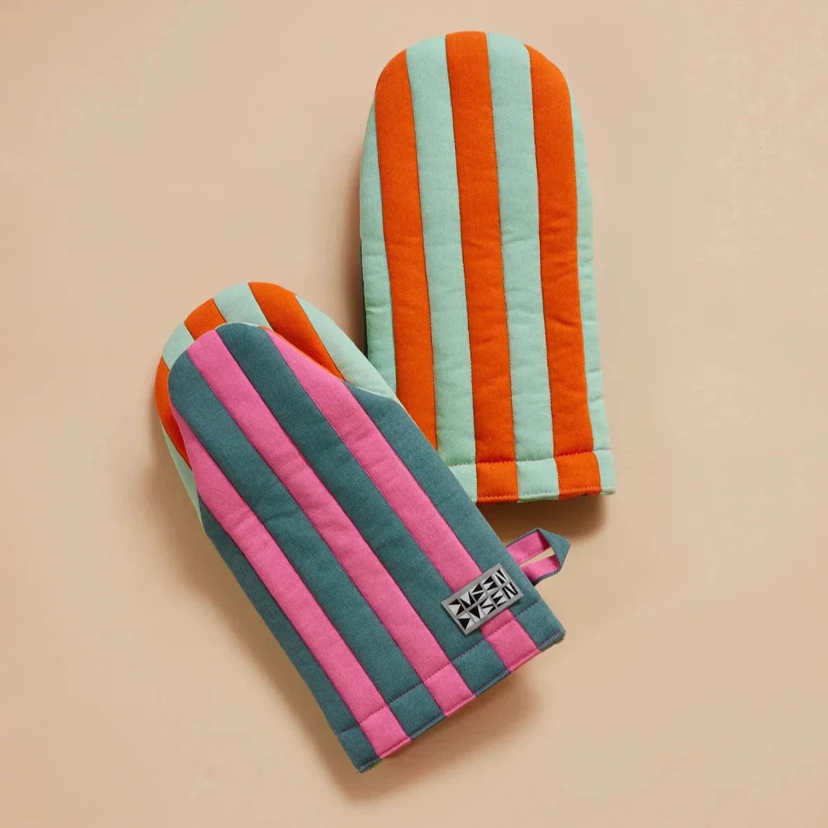 Ginger Oven Mitt by Dusen Dusen – group shot showing both sides of the mitt, featuring bold stripes in pink, teal, orange, and mint, displayed on a beige background.