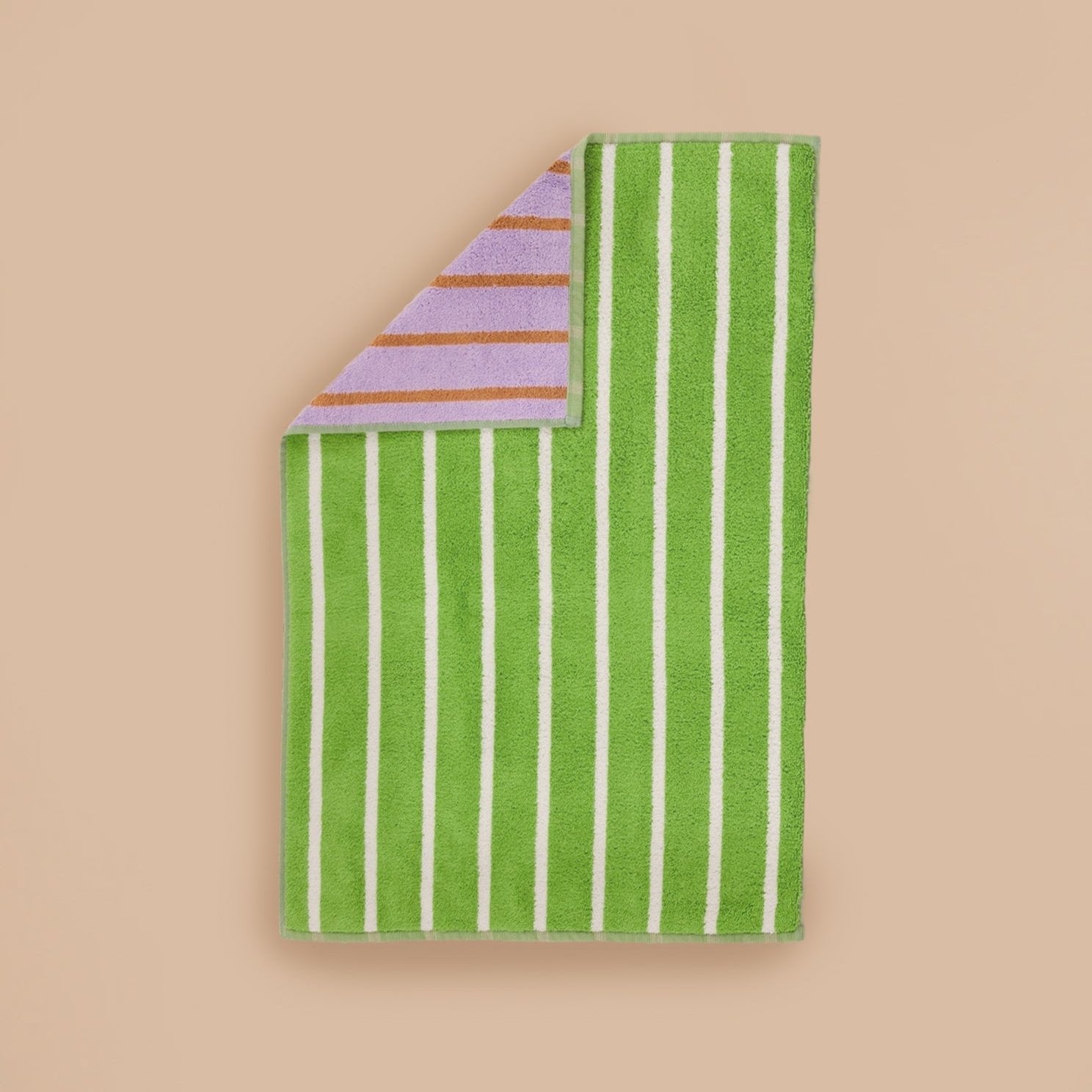 Glass Stripe Hand Towel by Dusen Dusen – a green towel with white stripes on one side and lavender with brown stripes on the reverse, displayed flat on a beige background.