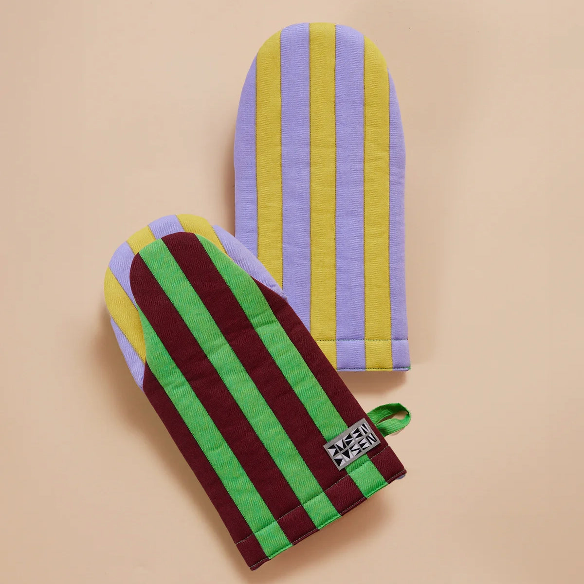 Jalapeño Oven Mitt by Dusen Dusen – group shot showcasing both sides of the mitt, featuring bold green and burgundy stripes with lavender and yellow on the reverse, displayed on a beige background.