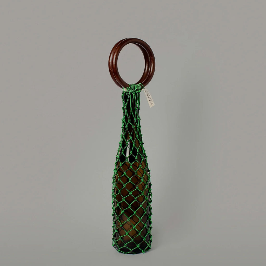 Front view of the 0/0 Bag in Neon Green Black by Tanchen, featuring the neon green netting and sleek wooden ring handle.