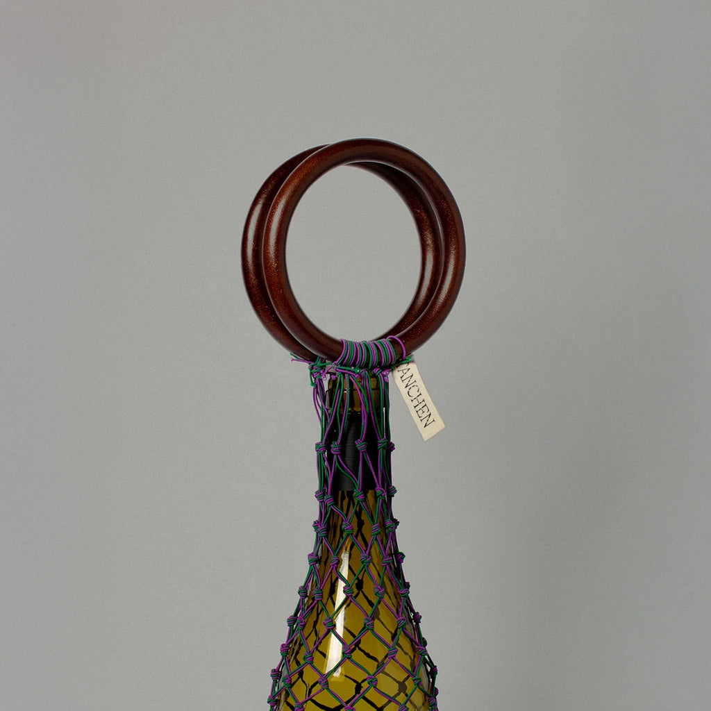 Close-up detail shot of the 0/0 Bag in Purple Green by Tanchen, showcasing the intricate purple and green netting and branded tag.