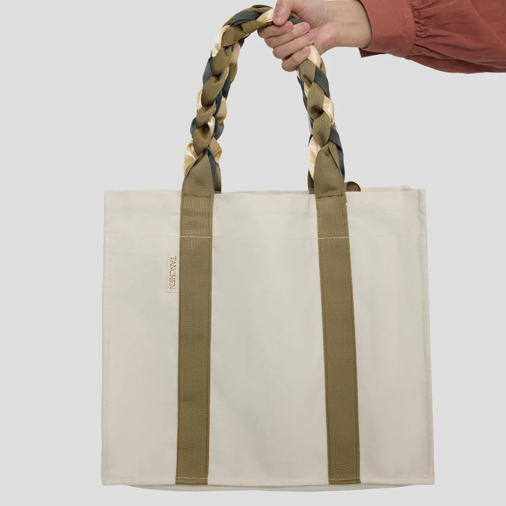 Cream and Tan Picnic Bag Fizz! by Tanchen, shown being held by hand to display its size and functionality.