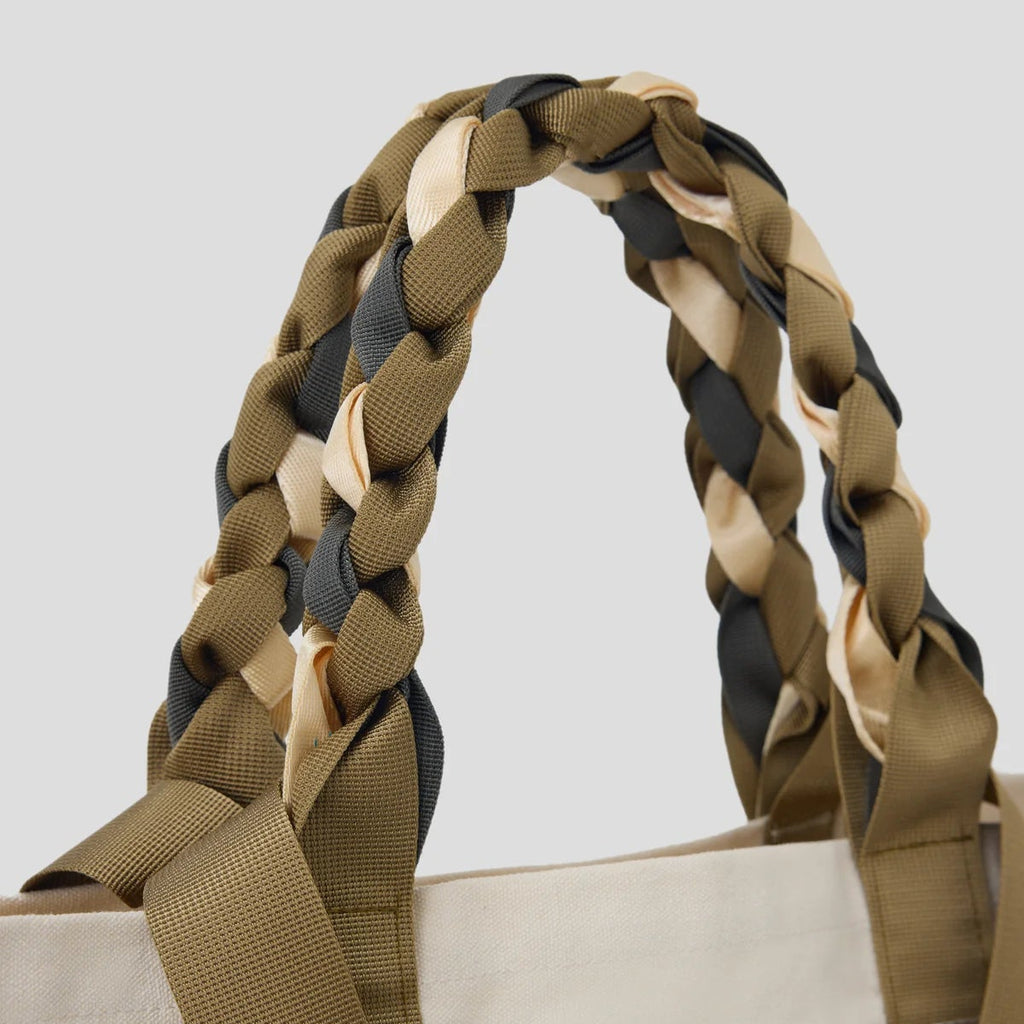 Close-up of the braided nylon ribbon handles of the Cream and Tan Picnic Bag Fizz! by Tanchen, showcasing its craftsmanship and durable construction.