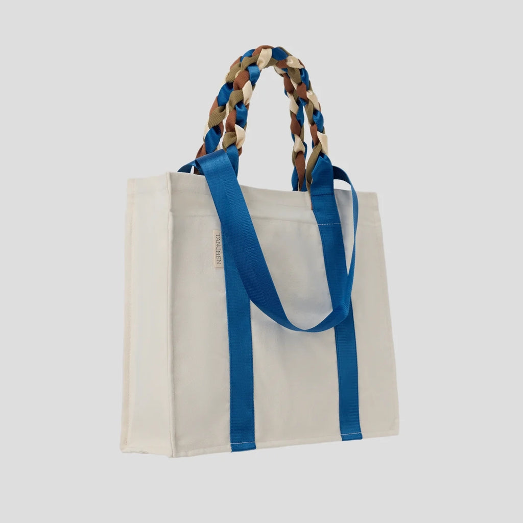 Side view of the Picnic Bag Glou! by Tanchen, highlighting its spacious design and braided nylon ribbon handles.